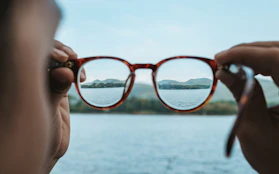 A woman looking through a pair of glasses