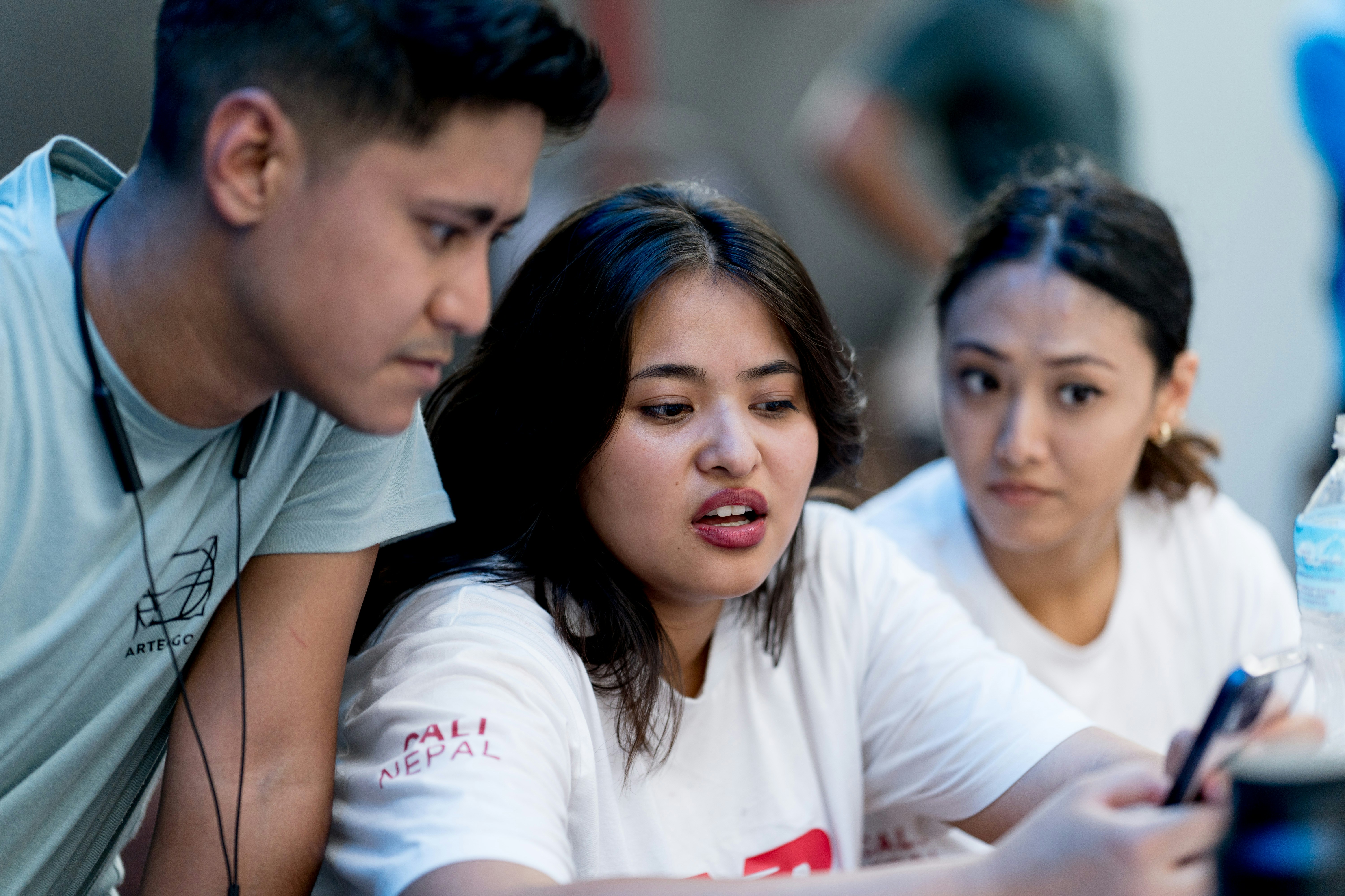 A man and a woman looking at a cell phone
