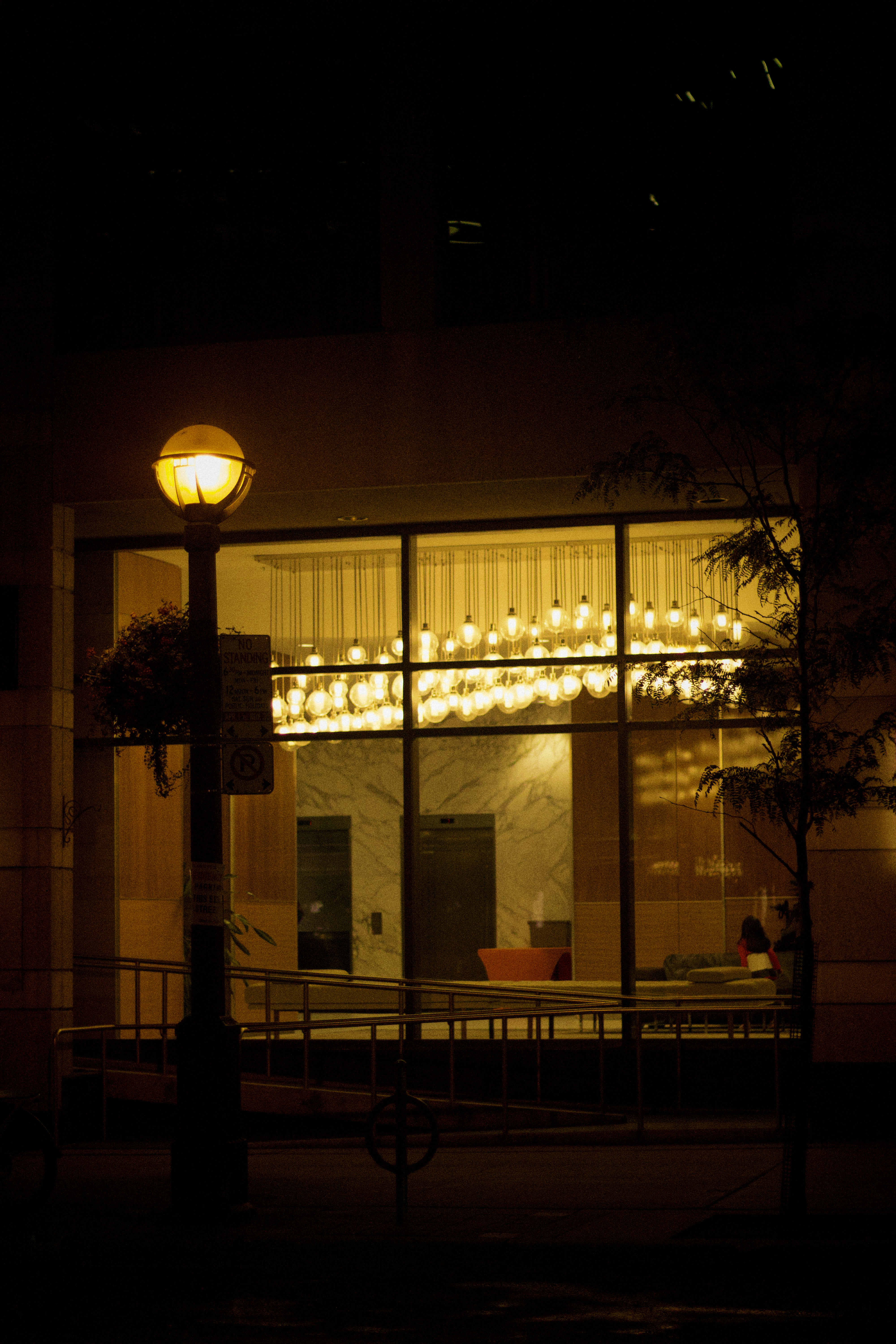 A street light in front of a building at night