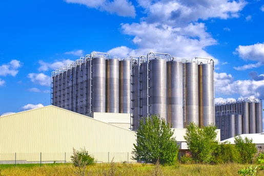 A large building sitting next to a lush green field