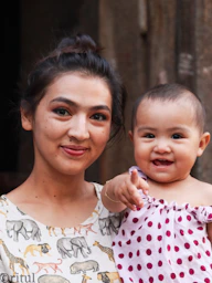 A woman holding a baby in her arms