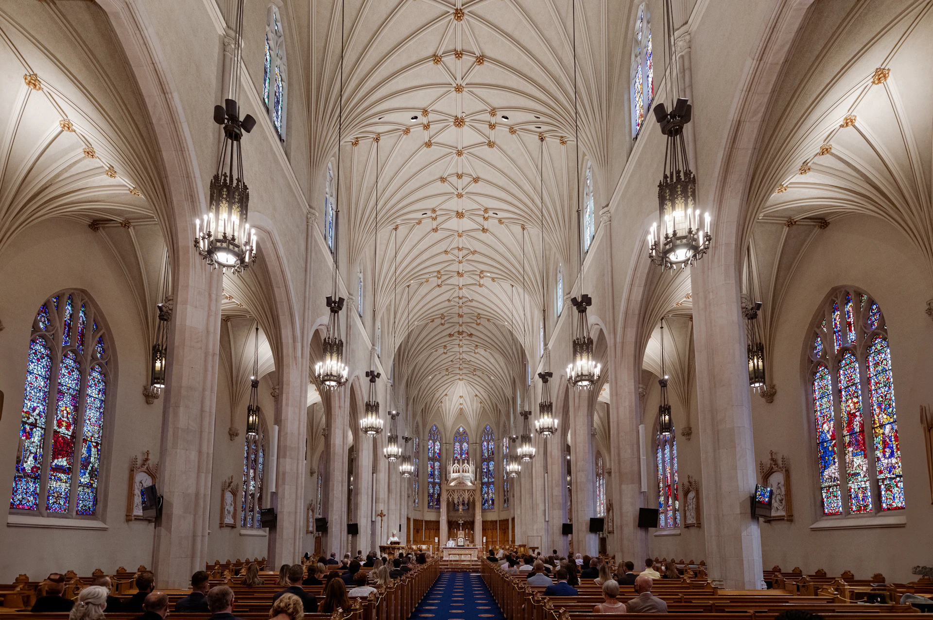 A large cathedral with stained glass windows and pews