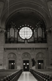 An empty church with pews and a large window