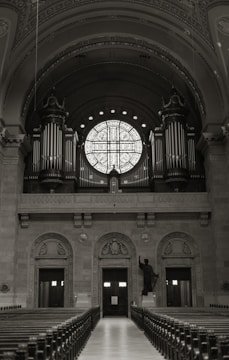 An empty church with pews and a large window
