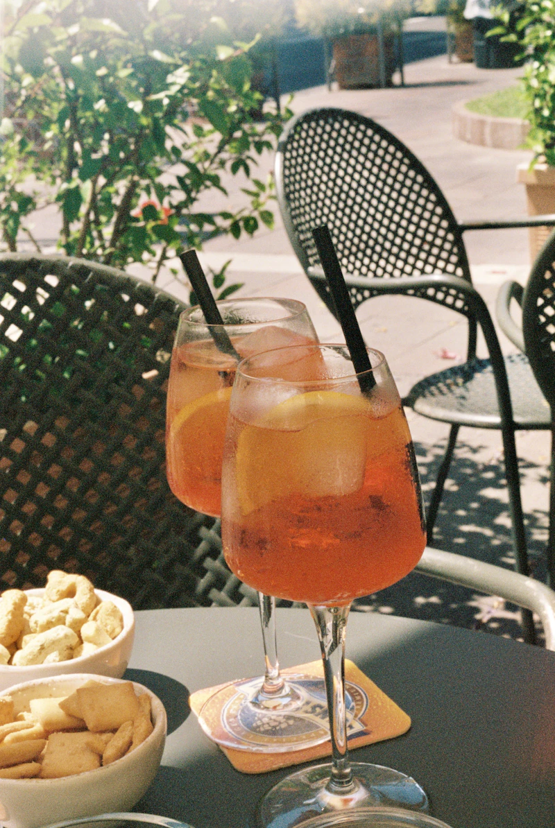 Aperol Spritz cocktails on a sunlit Italian terrace