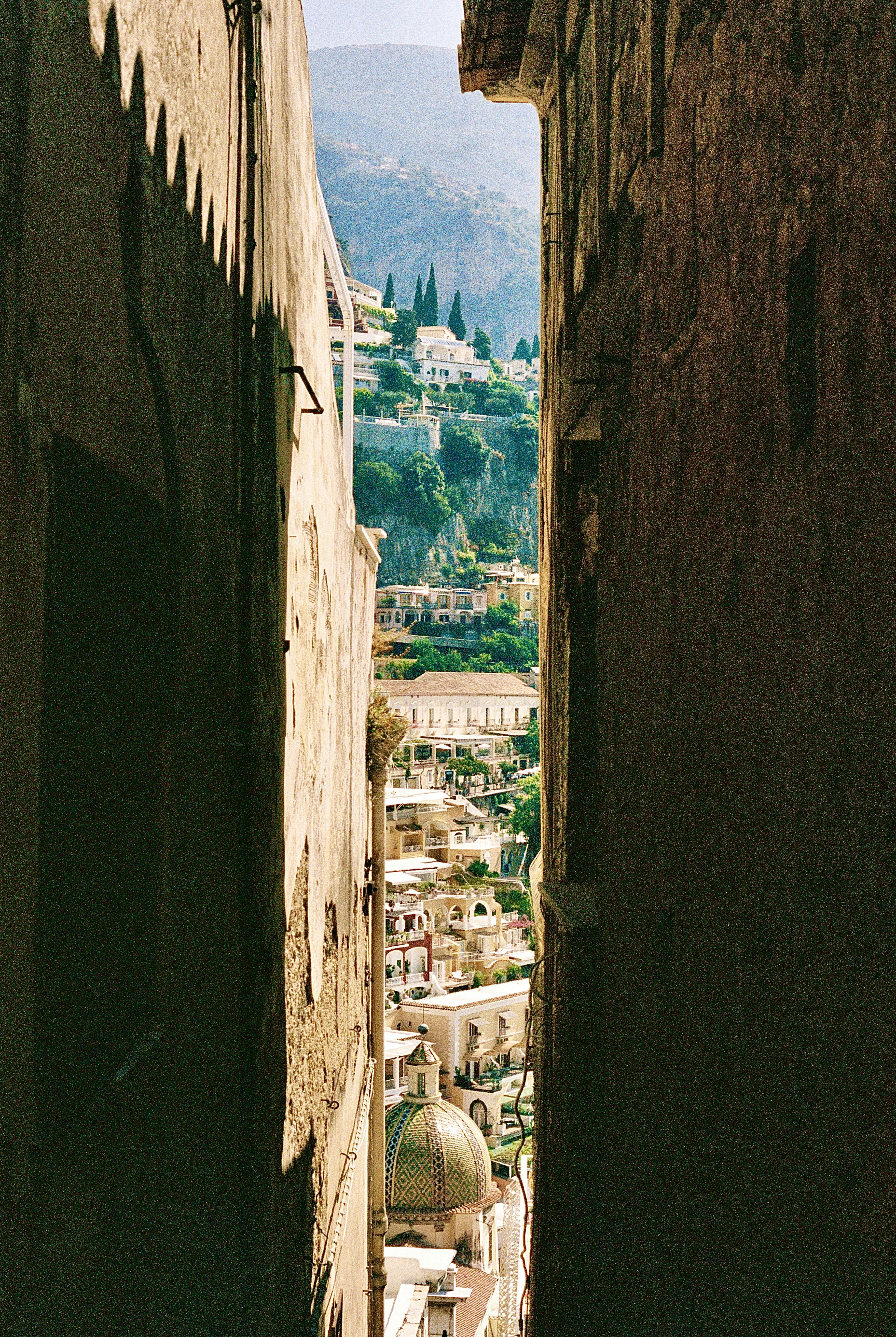 A narrow alley way with a view of a city