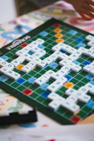 A close up of a person playing a game of scrabble