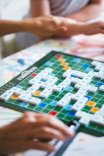 A group of people playing a game of scrabble