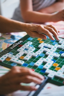 A couple of people playing a game of scrabble