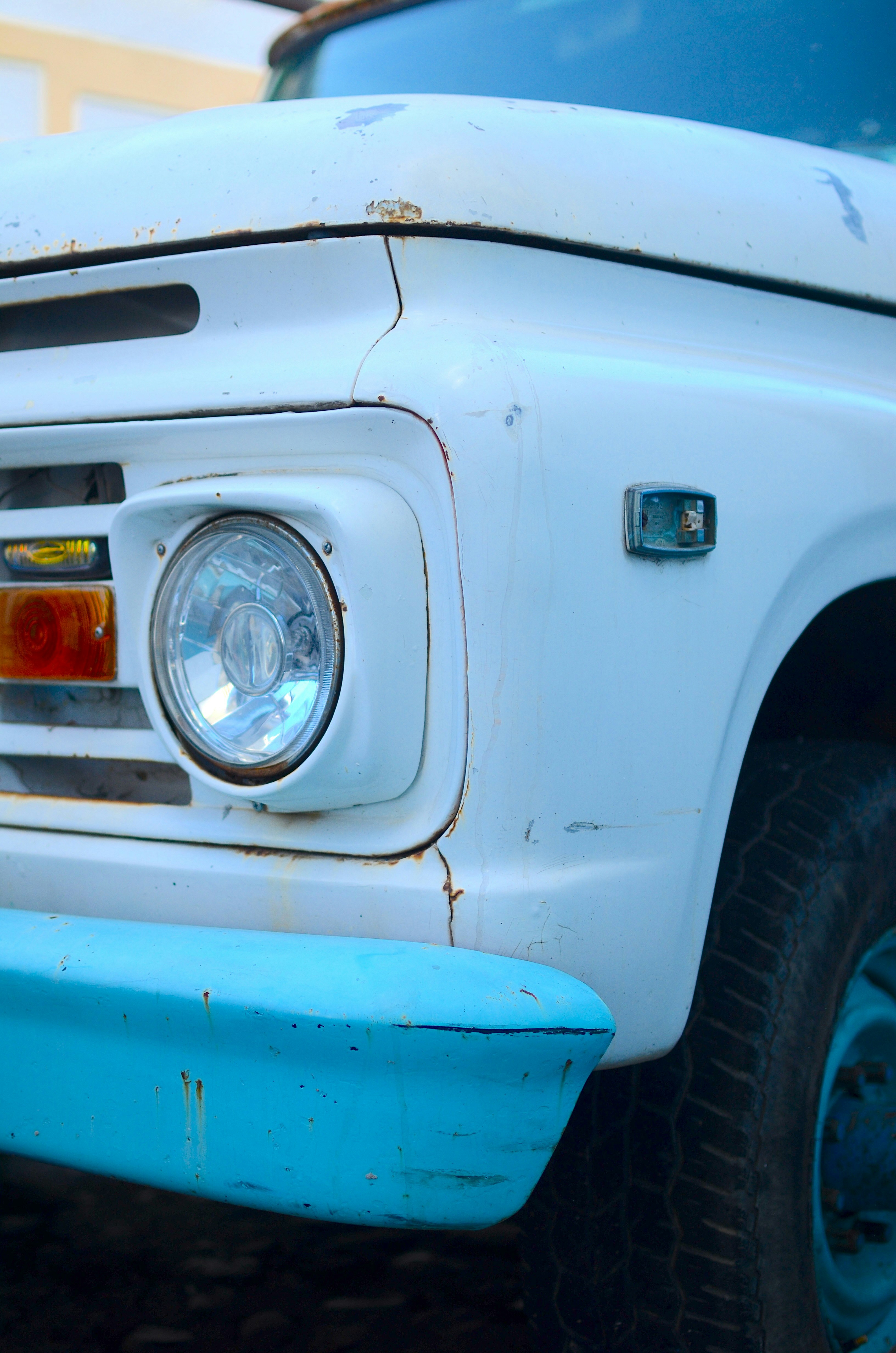 A close up of the front of a white truck