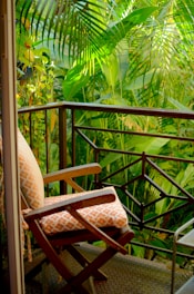 A balcony with a chair and a table on it