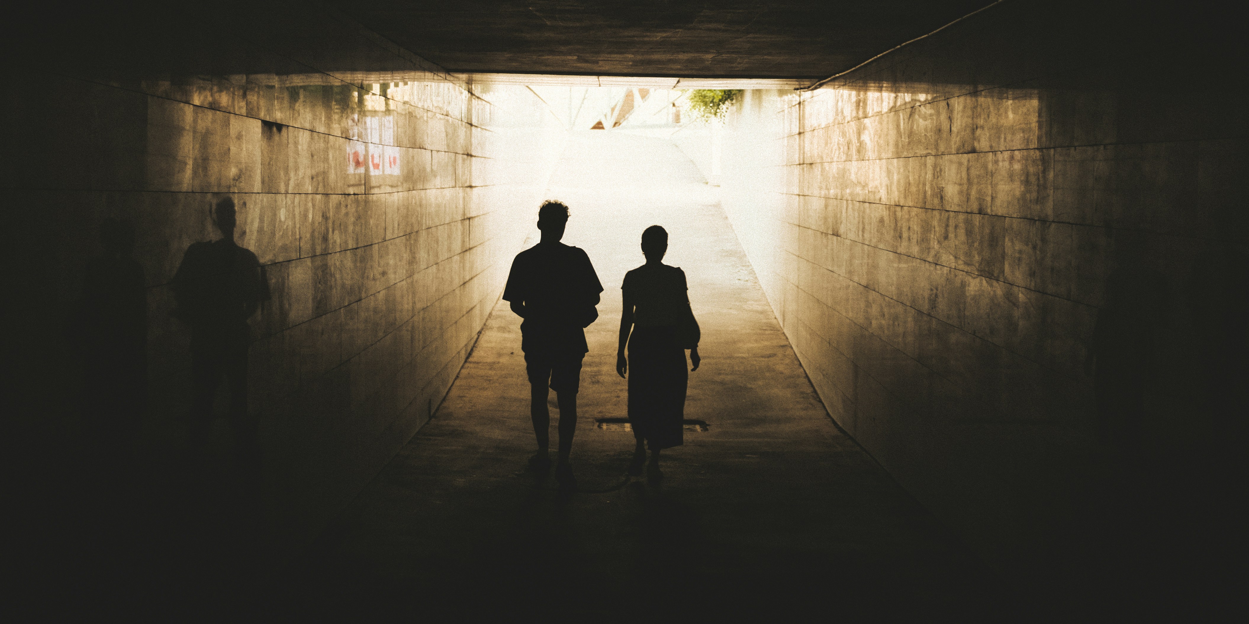 A couple of people standing in a tunnel