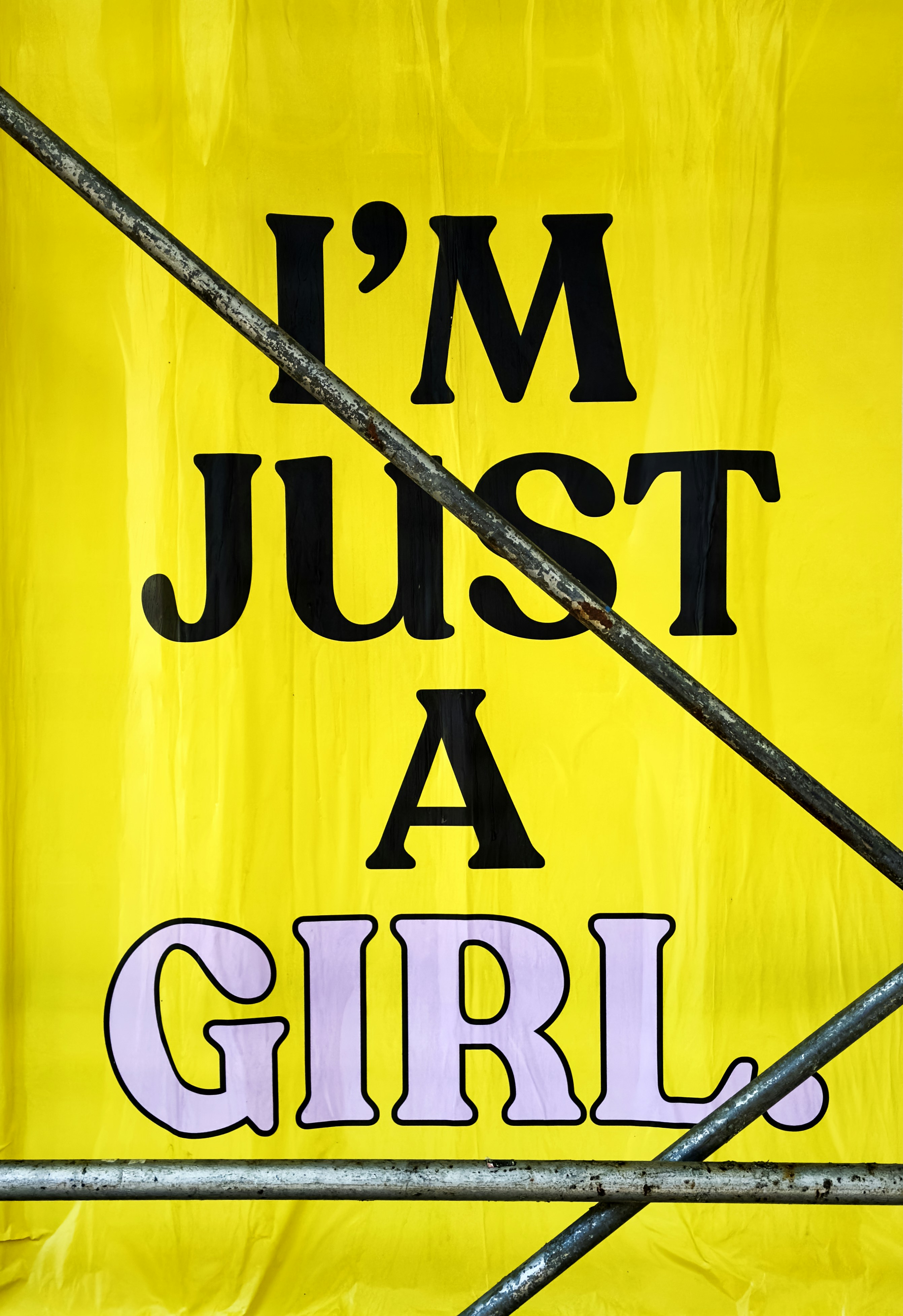 A yellow sign that says i'm just a girl