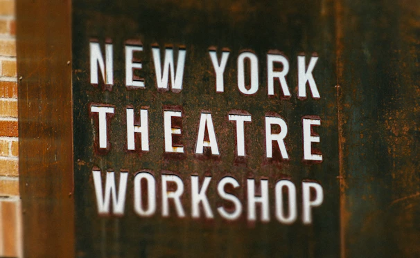 A sign that says new york theatre workshop