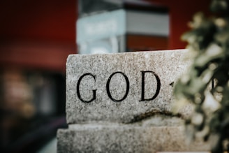 A stone block with the word god written on it
