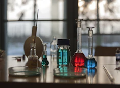 A table topped with flasks filled with liquid
