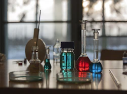 A table topped with flasks filled with liquid