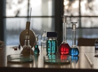 A table topped with flasks filled with liquid
