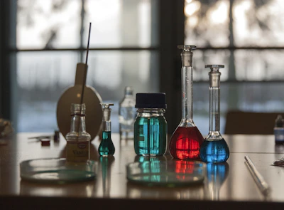 A table topped with flasks filled with liquid