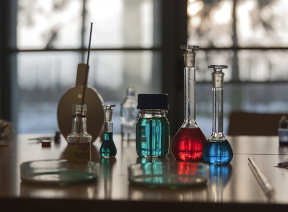 A table topped with flasks filled with liquid