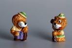 A couple of small figurines of bears on a table