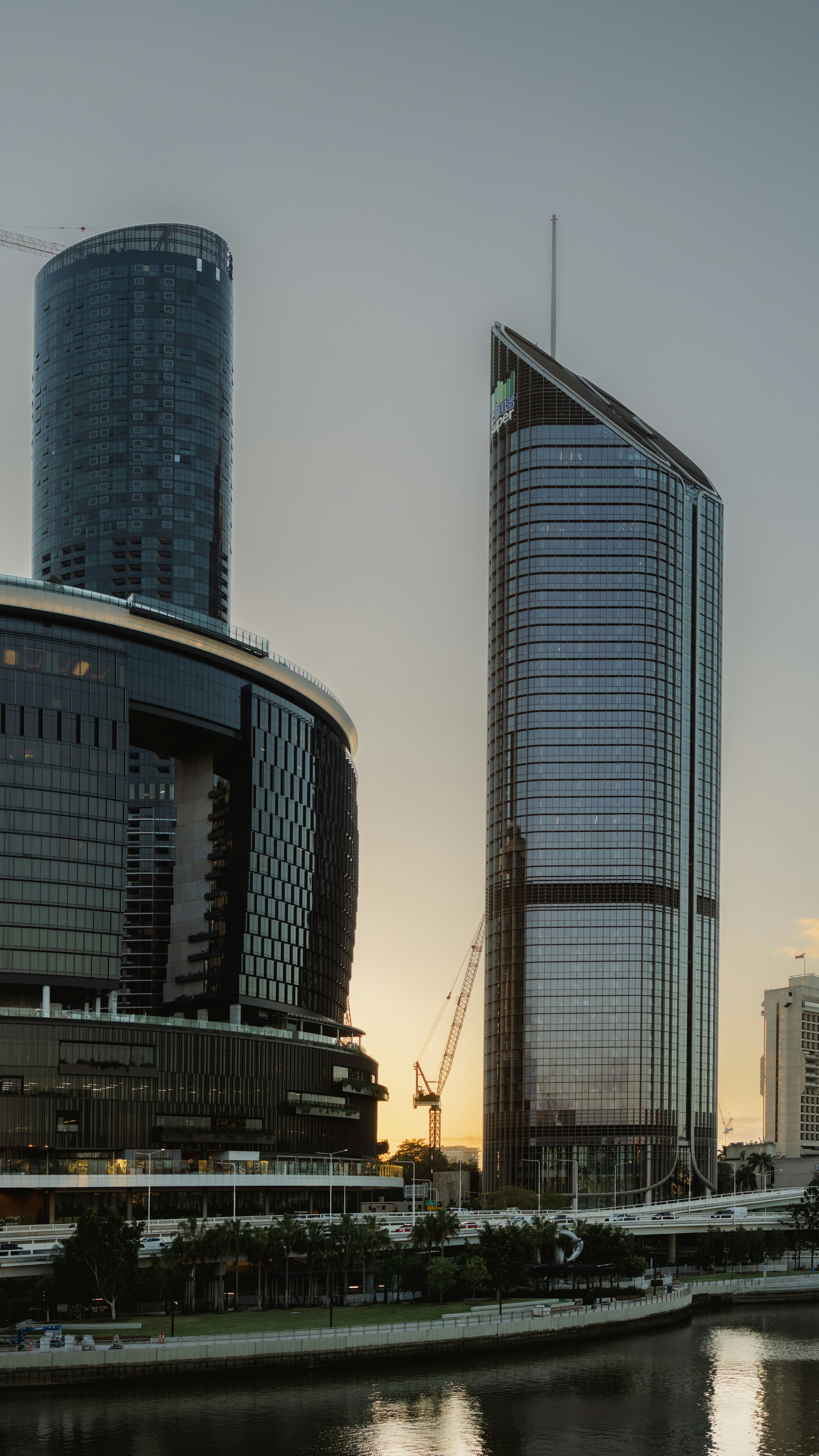 A body of water in front of some tall buildings