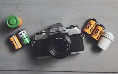 A camera, batteries, and batteries on a table