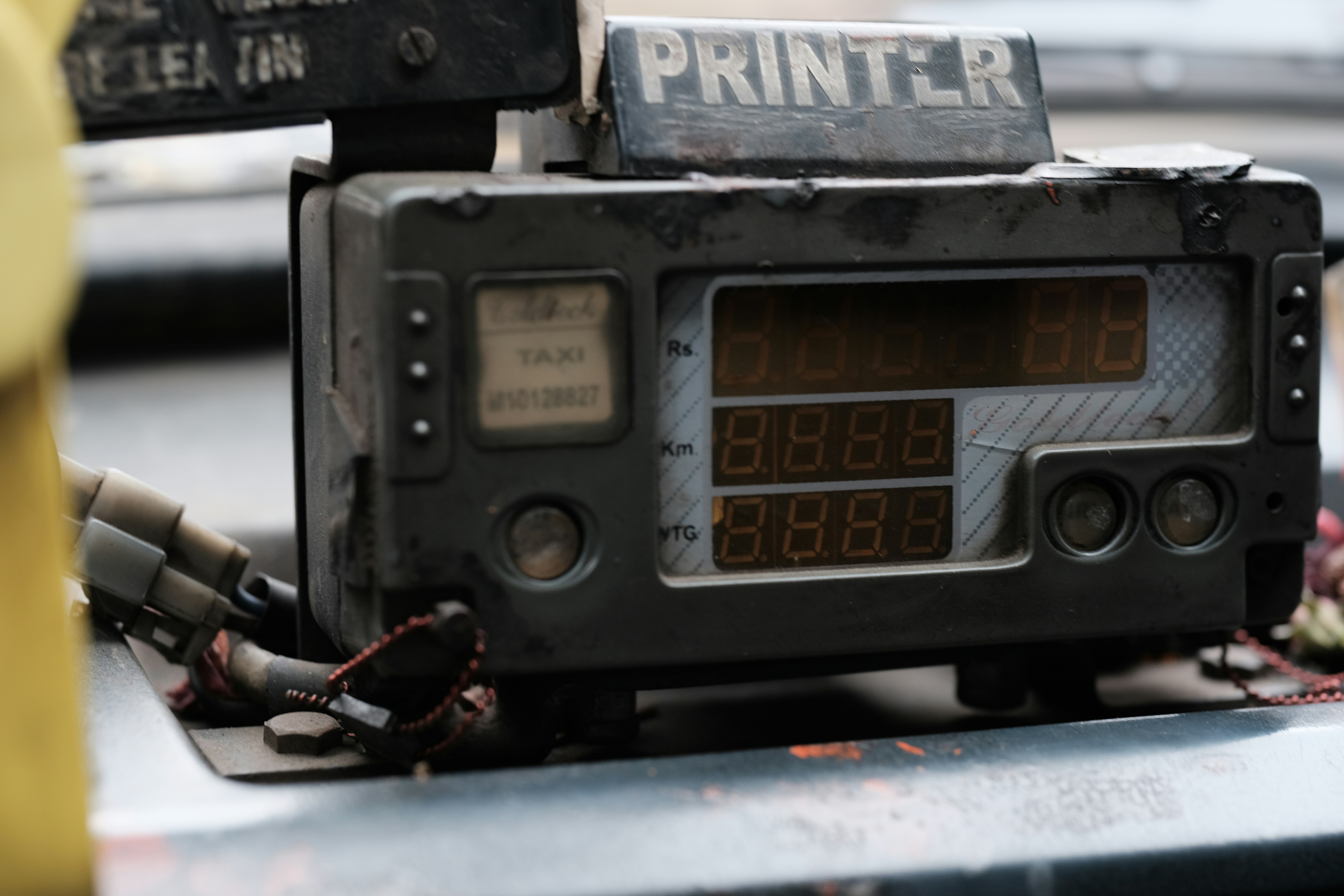 A radio sitting on top of a table next to a yellow fire hydrant
