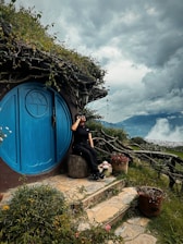 A woman taking a picture of a hobbot house
