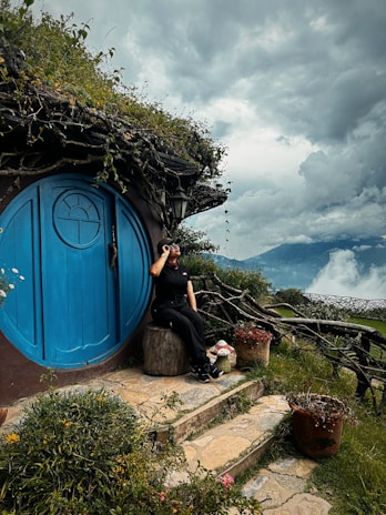 A woman taking a picture of a hobbot house