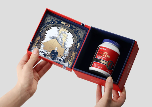 A person holding a red and blue box with a red and white object in it