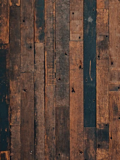 A close up of a wooden floor with a brown background