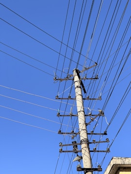 A telephone pole with lots of wires above it
