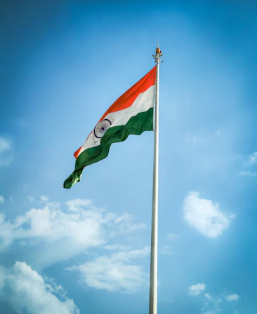 The indian flag is flying high in the sky