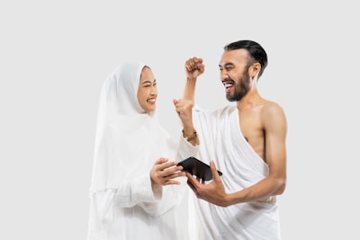 A man and a woman dressed in white