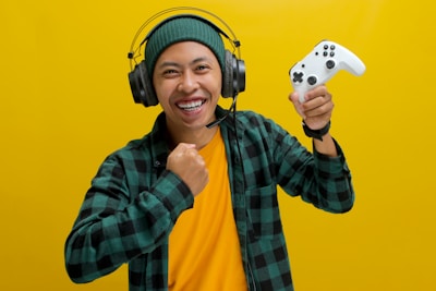 A man wearing headphones and holding a video game controller