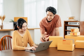 A man and a woman looking at a laptop