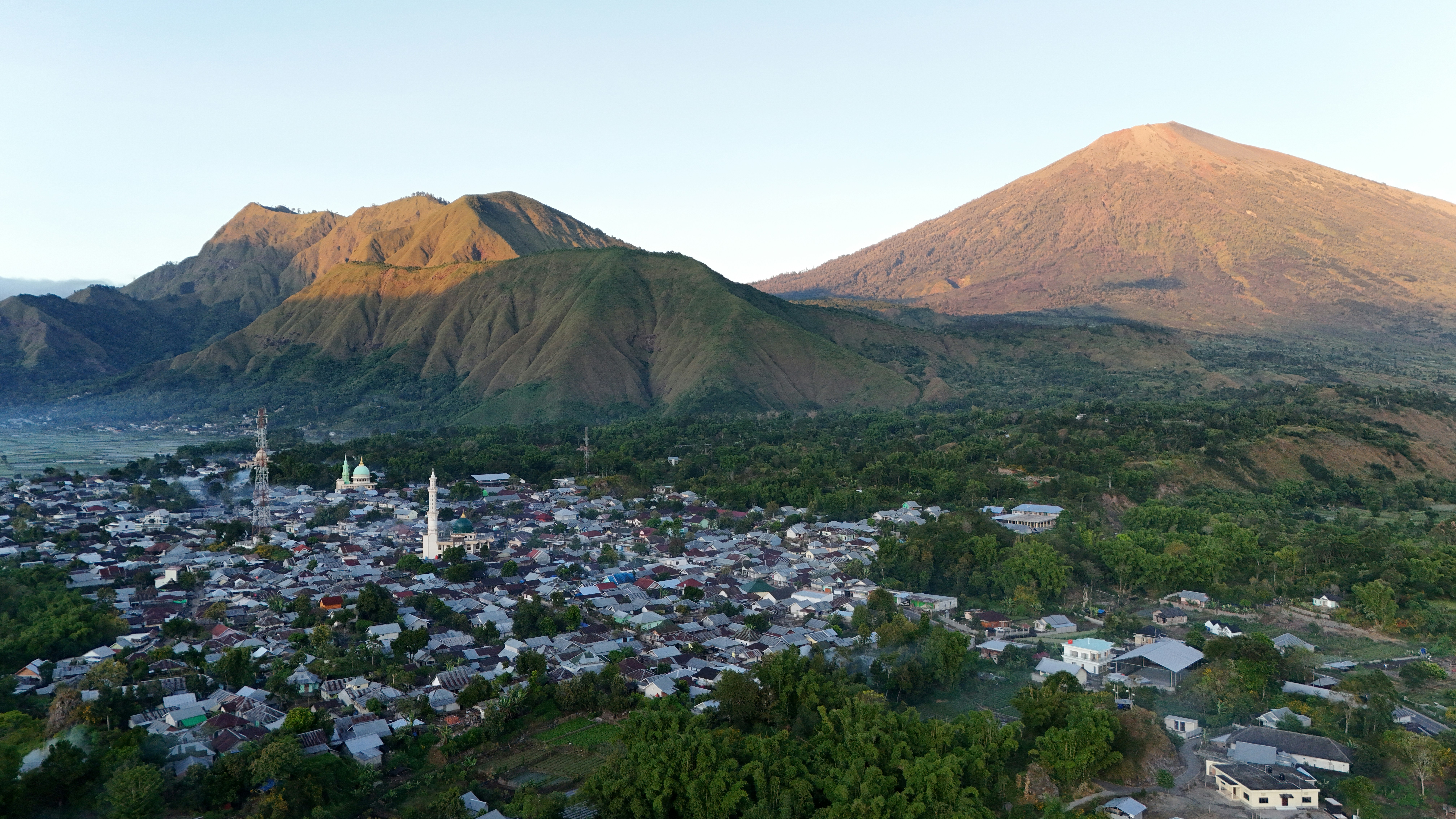 An aerial view of a city with mountains in the background