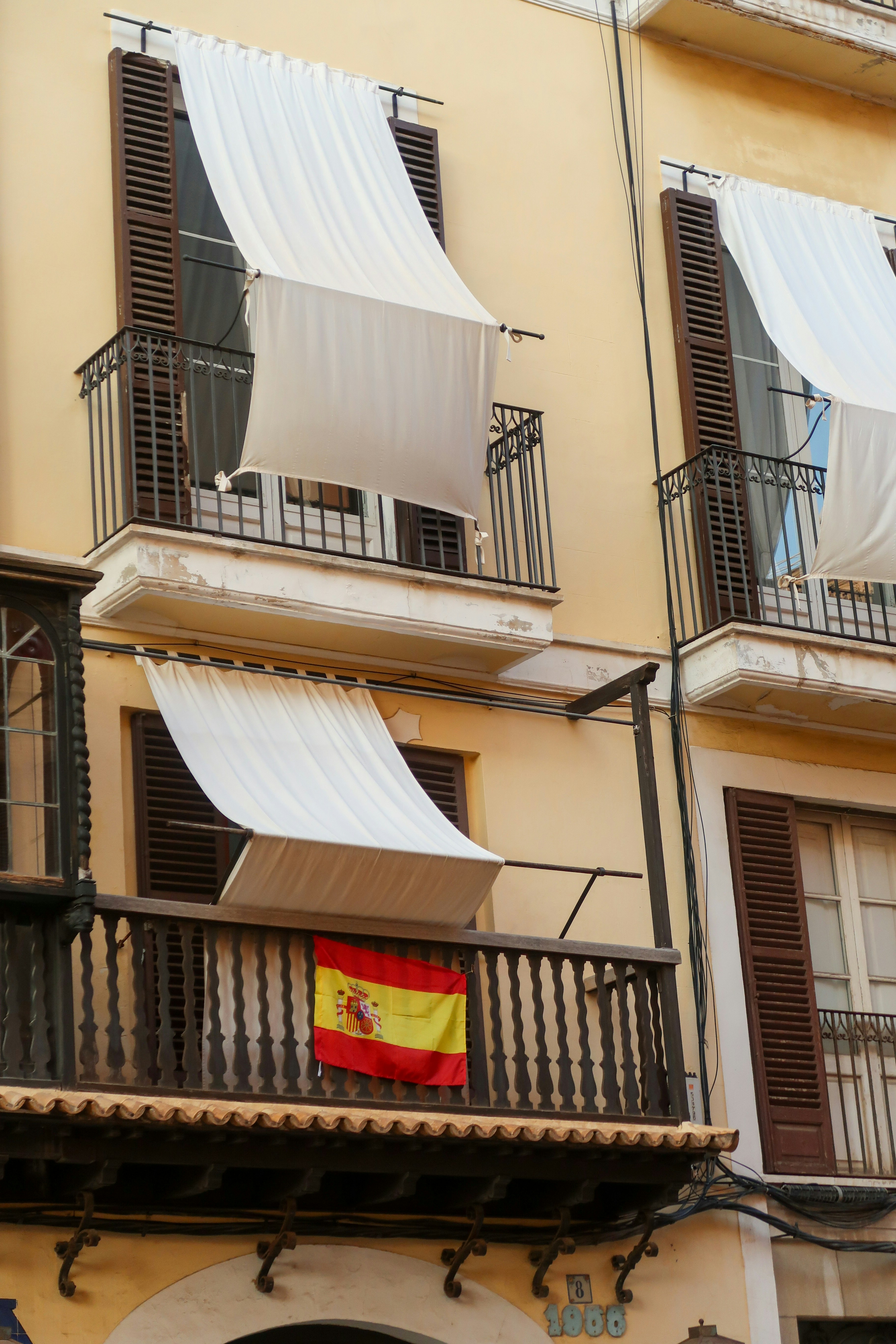 A balcony with a flag hanging from it