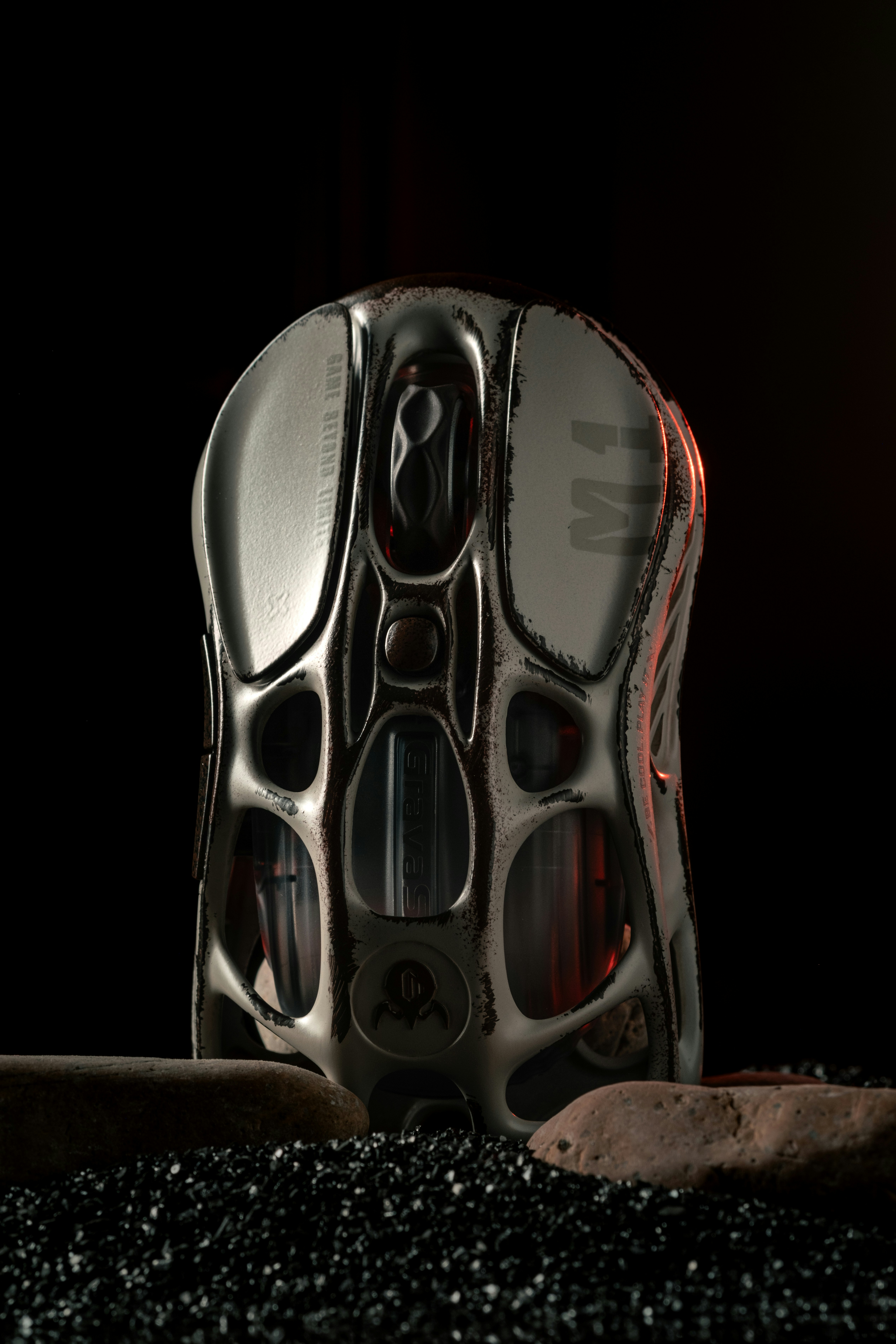 A pair of shoes sitting on top of a pile of black rocks