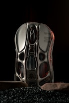 A pair of shoes sitting on top of a pile of black rocks