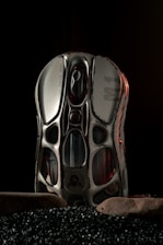 A pair of shoes sitting on top of a pile of black rocks