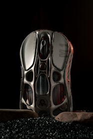 A pair of shoes sitting on top of a pile of black rocks