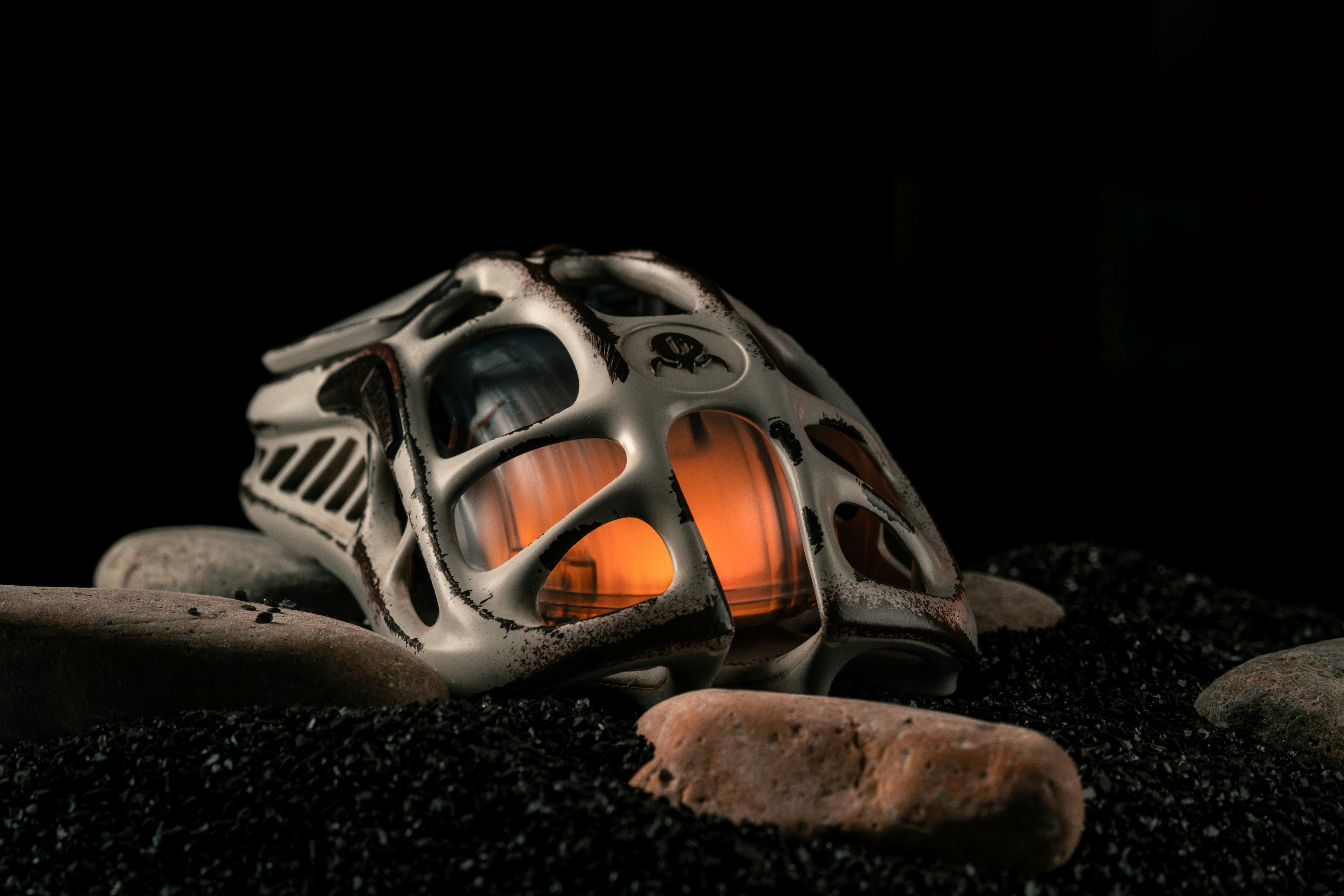 A lantern sitting on top of a pile of rocks