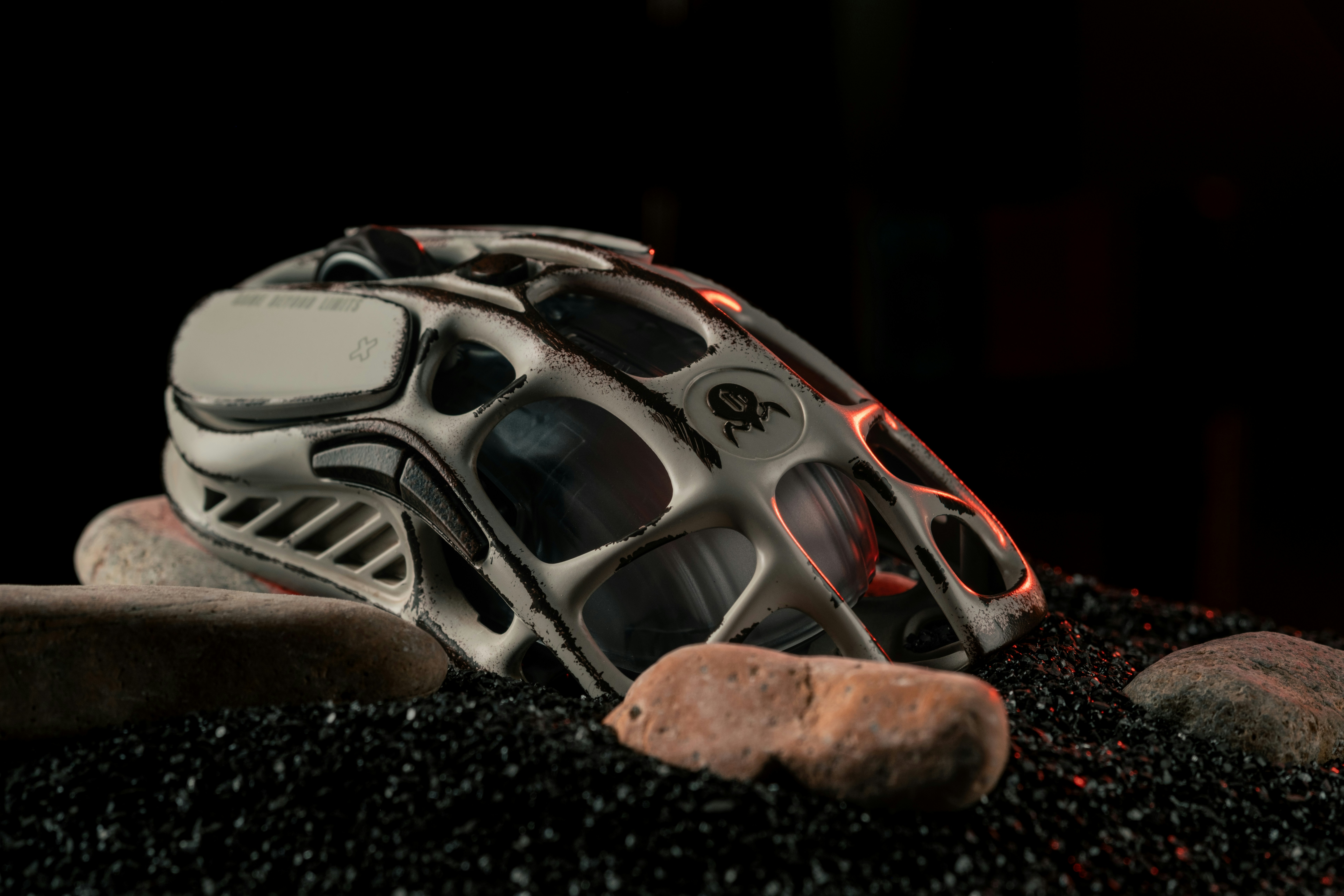 A helmet sitting on top of a pile of gravel