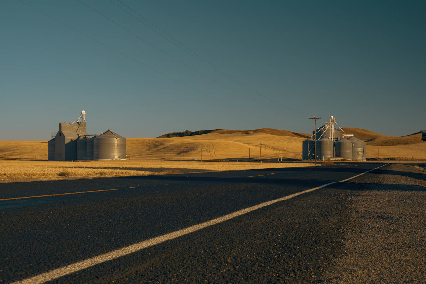 An empty road running straight through high desert country
