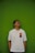 A man standing in front of a green wall