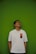 A man standing in front of a green wall