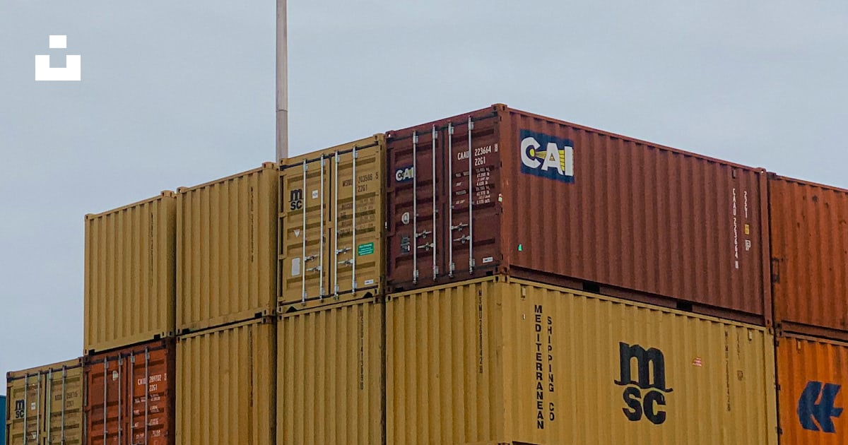 A large stack of shipping containers sitting on top of each other photo ...
