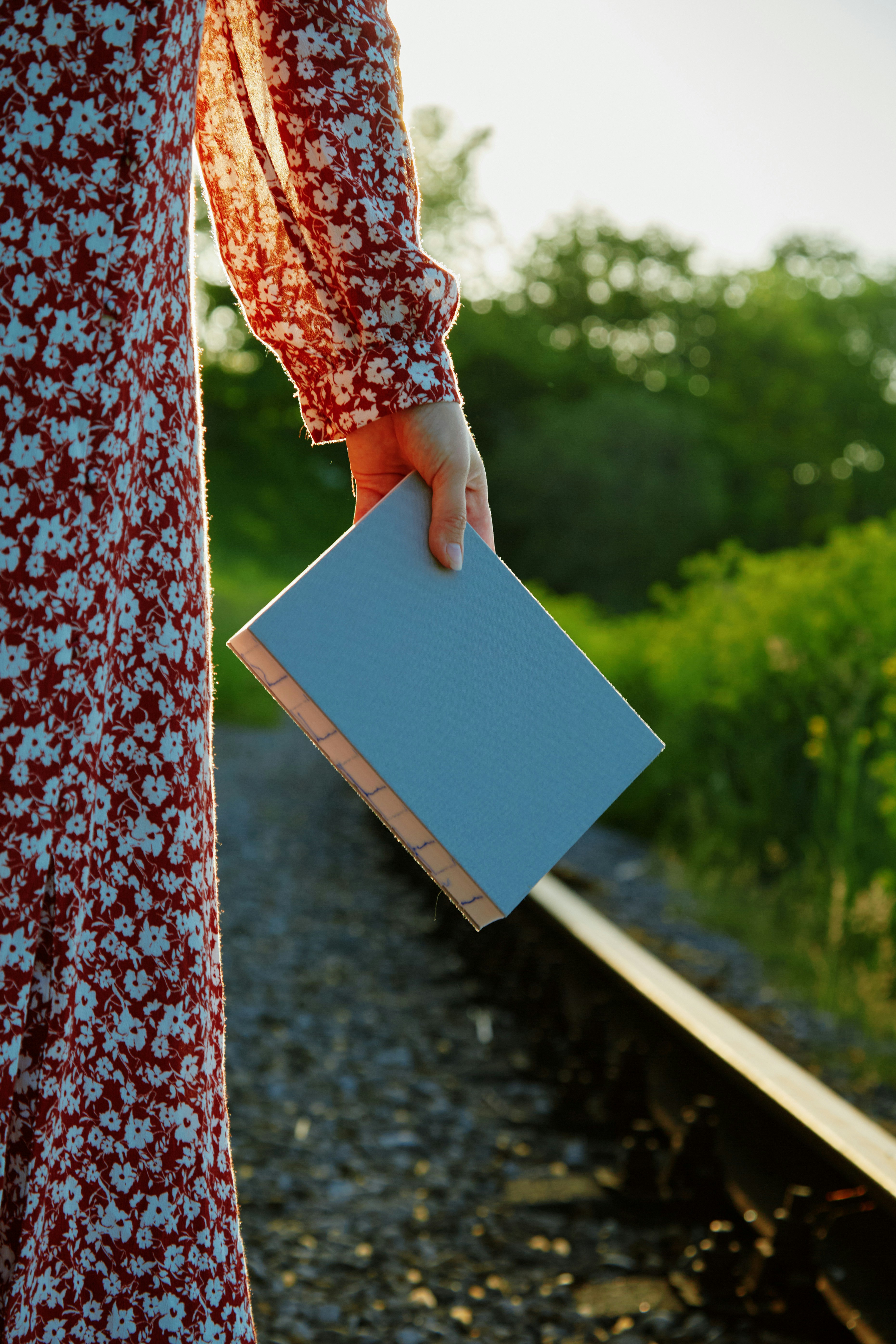 A woman in a red and white dress holding a blue box